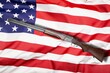 Shotgun over American Flag. Gun control and rights concept