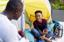 Image Of Smiling African American Boy With Father Eating Apples On The Camping