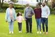 Image of happy multi generation african american family posing together outdoors
