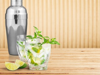 Wall Mural - Mojito cocktail or mocktail with lime, mint, and ice in a glass. Summer cold alcoholic non-alcoholic drink, beverage and cocktail recipe. Bar menu.