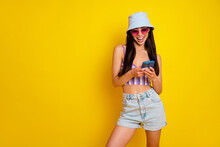 Photo Of Funny Sweet Lady Wear Striped Crop Top Cap Dark Glasses Chatting Modern Device Empty Space Isolated Yellow Color Background