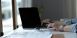© wichayada - Close up Business woman using calculator and laptop for do math finance on wooden desk in office and business working background, tax, accounting, statistics and analytic research concept