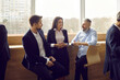 © Studio Romantic - Various colleagues communicate and discuss information after business event or corporate training. Three employees in business attire talk to each other during informal meeting during office break.