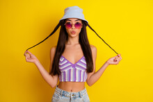 Photo Of Charming Flirty Lady Wear Striped Crop Top Cap Arm Dark Eyewear Send You Kiss Isolated Yellow Color Background
