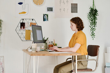Aufkleber - Young serious female freelancer or webdesigner concentrating on work over creation of new website while sitting in front of computer