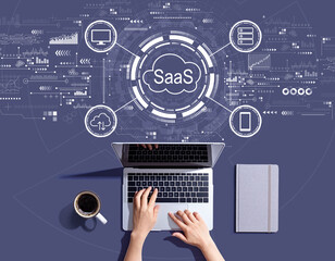 saas - software as a service concept with person using a laptop