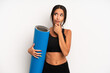 © kues1 - hispanic pretty woman thinking, feeling doubtful and confused. fitness and yoga concept