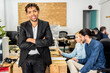 © ADDICTIVE STOCK - Positive black man in office with coworkers