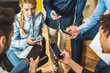 © ADDICTIVE STOCK - Group of colleagues browsing smartphones in office