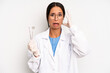 © kues1 - hispanic pretty woman screaming with hands up in the air. dentist student concept