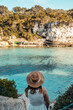 © ADDICTIVE STOCK - Anonymous lady on rocky coast and admiring sea