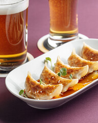 Wall Mural - Closeup on portion of japanese dumplings gyoza with beer