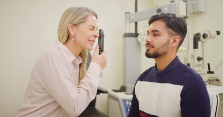 Sticker - Man at the optometrist doing an eye exam to check his eyesight. Indian male at a checkup with an opthalmologist to analyze for vision problems. Doctor examining a patients retina for disease