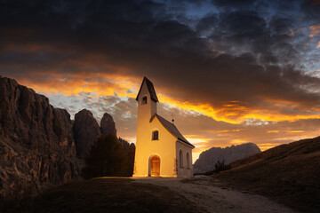Wall Mural - incredible view on small iilluminated chapel - kapelle ciapela on gardena pass, italian dolomites mo