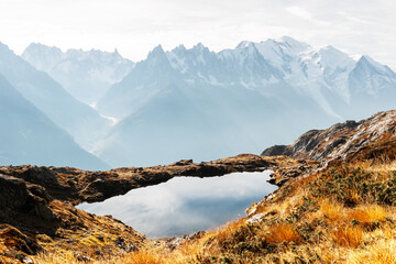 Wall Mural - Colourful sunset on Chesery lake (Lac De Cheserys) in France Alps. Monte Bianco mountain range on background. Vallon de Berard Nature Preserve, Chamonix, Graian Alps. Landscape photography