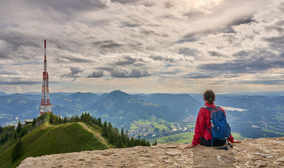 Wall Mural - nice senior woman hiking at Mount Gruenten in the Allgaeu Alps with awesomw view over Iller valley to Lake Alpsee and Lake of Constanz, Bodensee,  Bavaria, Germany