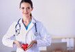 © lenets_tan - Young woman doctor holding a red heart