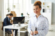 © Seventyfour - Portrait of young woman in eyeglasses with digital tablet standing at office of IT company