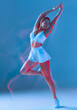 © Georgii - Full body front view of slim female in activewear dancing with hands up. Fitness, diet, skin and body care. Motion blur effect.