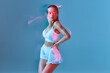 © Georgii - Tanned beautiful brunette lade enjoying dance. Sporty girl in white underwear on blue background.