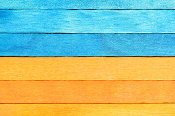 Wall Mural - Bicolor background from blue and orange wooden planks. Wooden textured background with natural patterns. Orange and Blue painted wooden boards arranged horizontally.