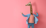 Man with head of giraffe on pink background