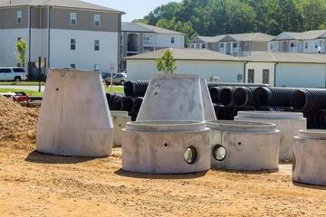 Concrete pipes to construct drainage systems on large cement drainage pipes for industrial building construction, selective focus.