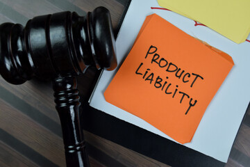 Wall Mural - Concept of Product Liability write on sticky notes with gavel isolated on Wooden Table.