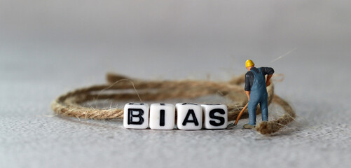 Business concept with white cube arranged in the word  ’BIAS' and miniature people. The concept of not being prejudiced.
