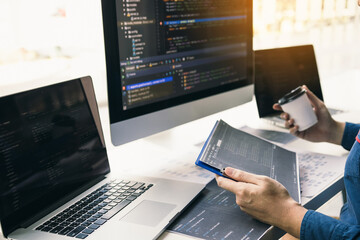 Wall Mural - asian man working code program developer computer web development working design software on desk in