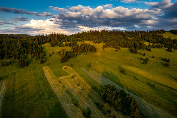 Sticker - Meadows and pasture on rolling hills in mountains, drone view. Summer in countryside in Poland
