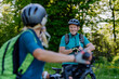 © Halfpoint - Portrait of active senior couple riding bicycles at summer park, standing on path and looking at camera