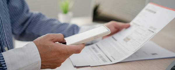 hands use the phone to scan qr codes to receive discounts on electricity bill payments at the office