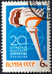 Wall Mural - USSR - CIRCA 1965: A stamp printed in USSR Russia shows a Torch with inscription 20 years of World Federation of Democratic Youth from series 20 years of international organizations , circa 1965