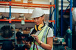 © kelvn - Woman Engineers is controlling robot arm machine welding steel, worker using forcing welding with a control screen which is used for precision welding control.