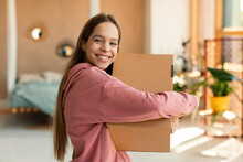 Delivery And Shopping. Excited Teen Customer Girl Hugging Cardboard Box And Smiling, Receiving New Clothes From Store