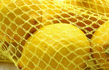 Wall Mural - close-up fresh lemons on a string bag
