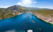 © moofushi - Aerial view of a large fish farm at a smal bay in the blue, mediterranean sea in Greece