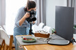canvas print picture - blogging, profession and people concept - female food photographer with camera photographing cake in kitchen at home
