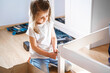 © velirina - Dad,little girls daughters assemblle wooden baby bed according to instructions in kids room. Helping father, mounting children's furniture. Self-assembly by guide.Family activity together.Home design