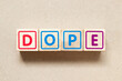 Color letter block in word dope on wood background