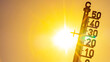 Hot weather - Heat wave / Summer heat background - Thermometer yellow orange sky and sun rays