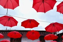 Red Umbrella Decorations Against Blue Sky