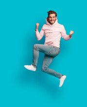 Full Size Photo Of Young Happy Excited Smiling Positive Man Jumping Isolated On Light Blue Color Background.