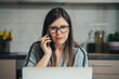 © Tijana - Beautiful Business Woman Working At Home On Her Laptop Computer While Talking On A Mobile Phone