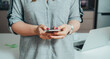 © Tijana - Close Up Photo Of Woman Hands Typing Text Message On Her Smartphone At Home Office