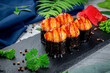 Baked sushi rolls with ayashi cap of crab sauce and unagi sauce. Traditional Japanese Cuisine