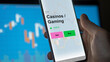 © maurice norbert - An investor's analizing the casinos / gaming etf fund on a screen. A phone shows the prices of Casinos / Gaming