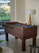 Modern living or family game room with a football table soccer game. Indoor sport game for social and family relaxing.
