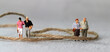Rope and miniature people. The concept of family feud.

